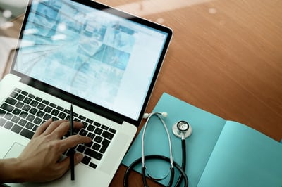 top view of Medicine doctor hand working with modern computer and smart phone on wooden desk as medical concept-1 top view of Medicine doctor hand working with modern computer and smart phone on wooden desk as medical concept-1